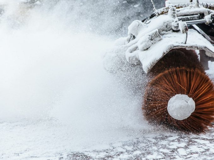 Snow plow does removal after blizzard in winter. Snow blower in motorway. Winter service on road